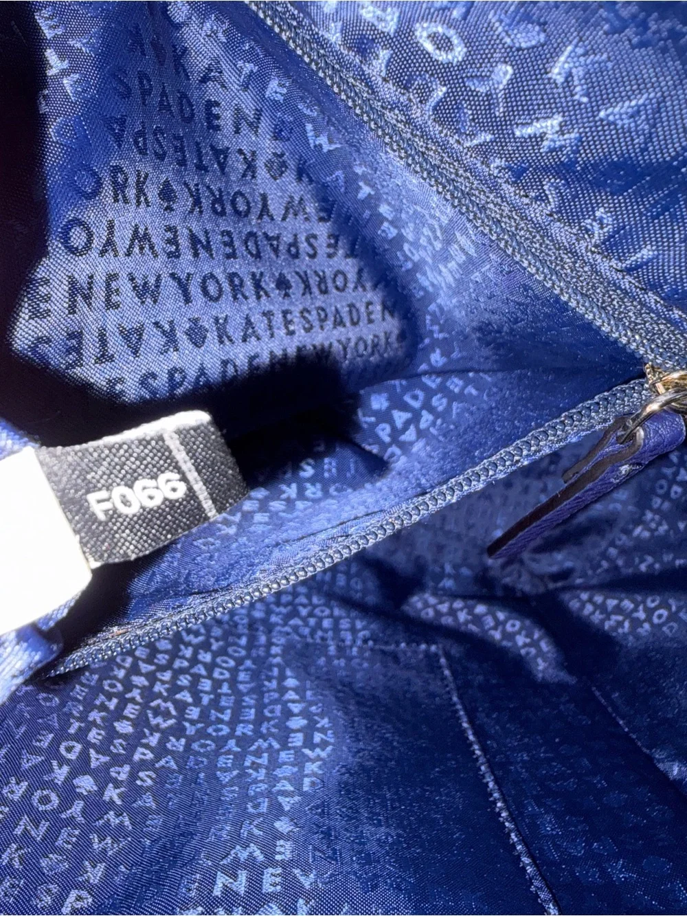 kate spade pebbled leather tote in navy with gold logo